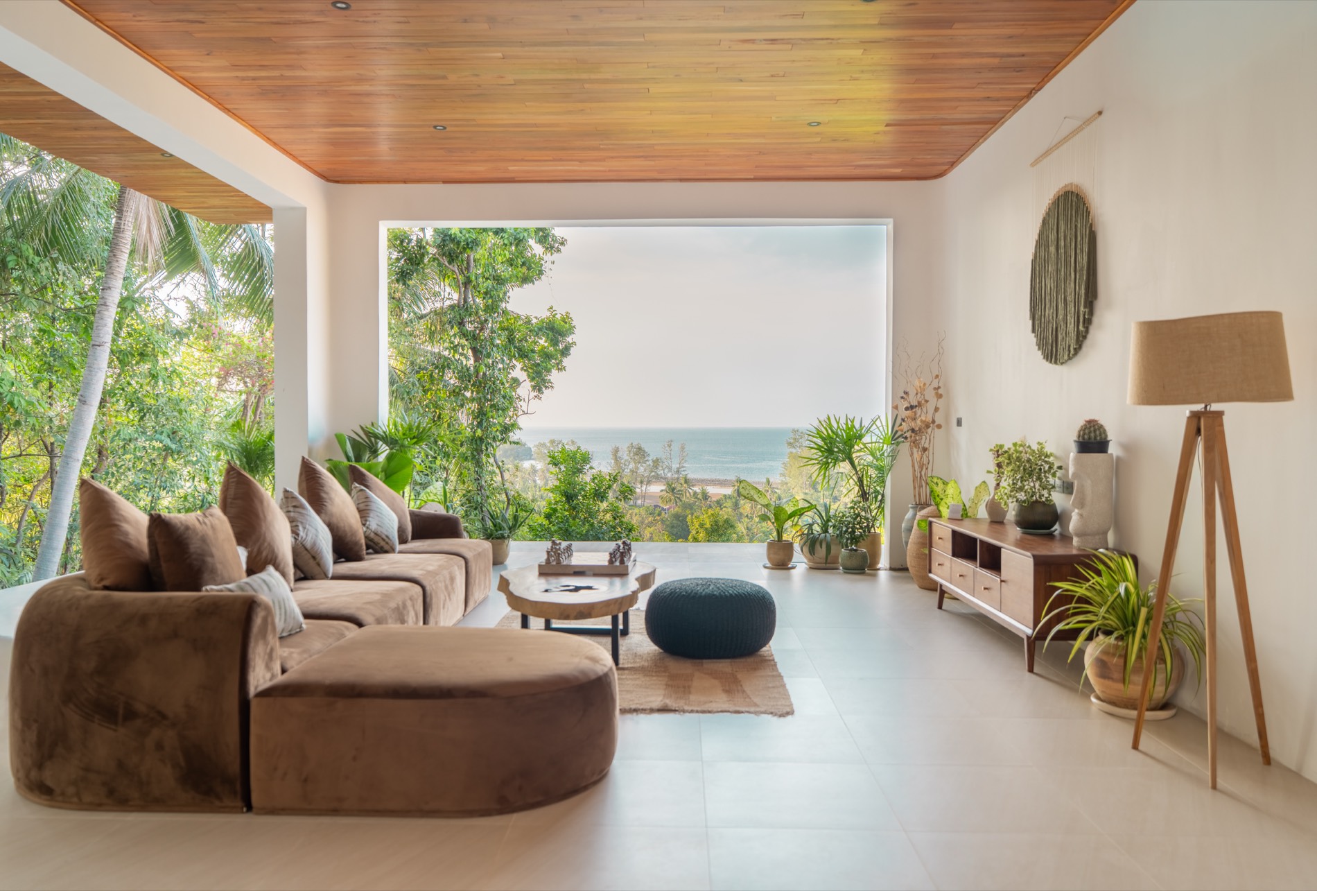 The finished showroom residence at Gaia: living space with timber ceiling opening to the sea view over Chaloklum Bay